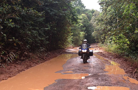 Krista rides a muddy road