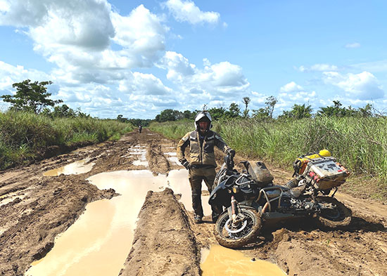 Muddy motorcycle on a muddy track.