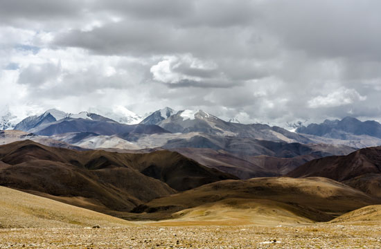 Landscape flowing from plains to hills to mountains.