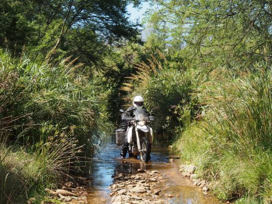 Riding through flooded rocky trail.