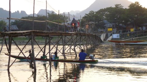 Pat Thomson navigating bridge in Laos. 