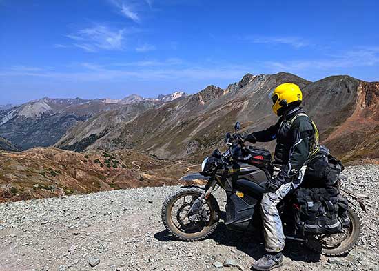 Kevin Edwards overlooking a twisty mountain road and valley.