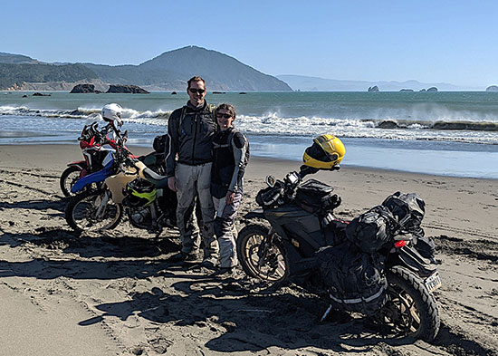 Amy and Kevin Edwards with motorcycles parked on the beach