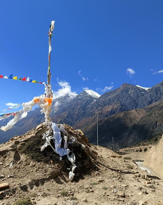 John Deikis, Nepal flags on mountain top.