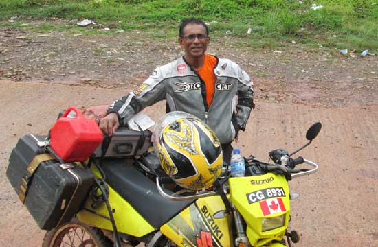 Moe Hanif and bike in Guyana.