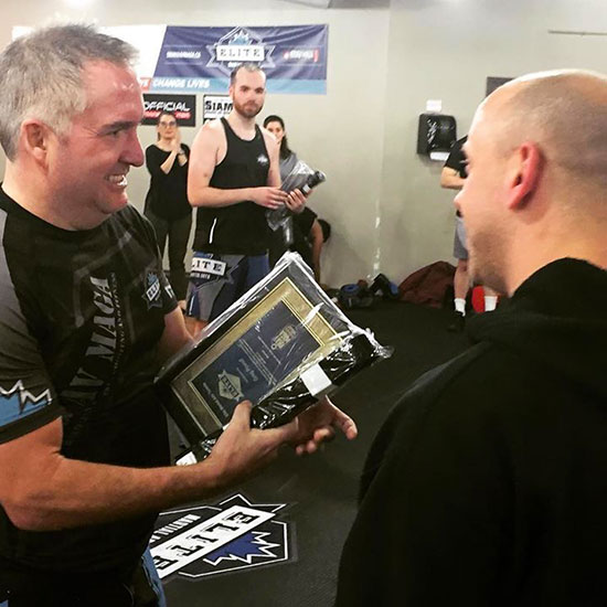 Greg Powell receives his black belt.