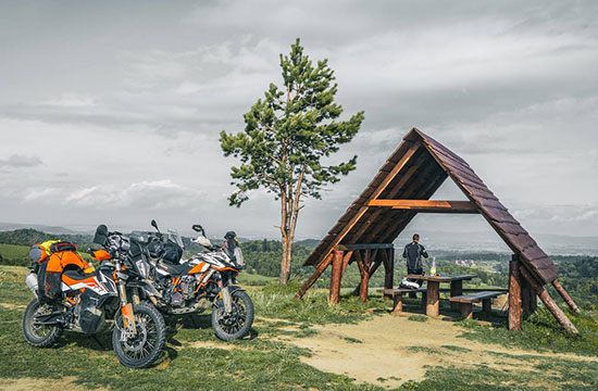 Motorcycle travellers taking a rest and vista break under shelter