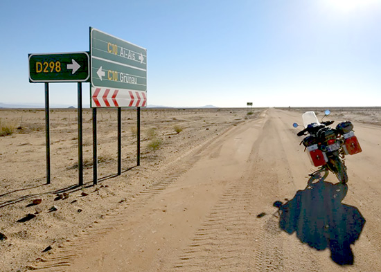George Ciobanu. Motorcycle on dirt road in West Africa.