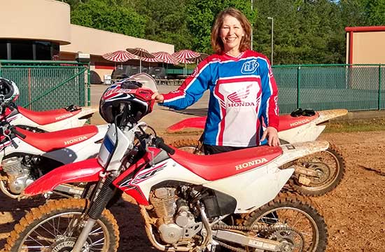 Annette and her Honda, ready to play in the dirt.