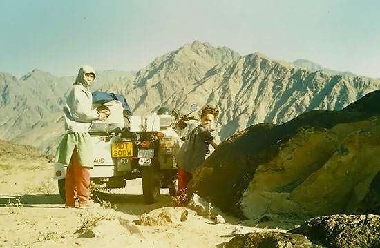 Emy and David Woodburn, family rest stop on a wild rocky mountain road with sidecar
