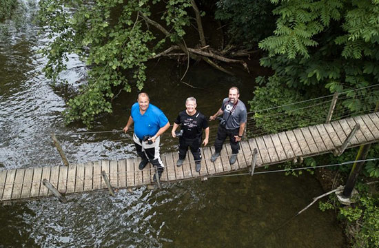 Chris Smith, Aerial shot of three men on a bridge