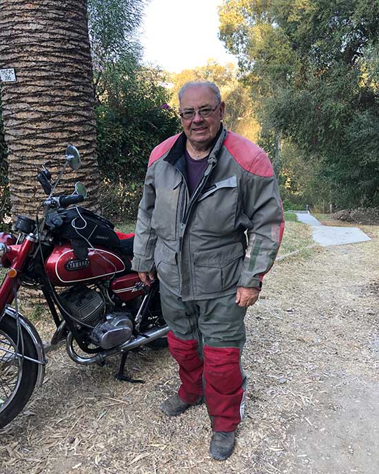 John Clarke beside his motorcycle