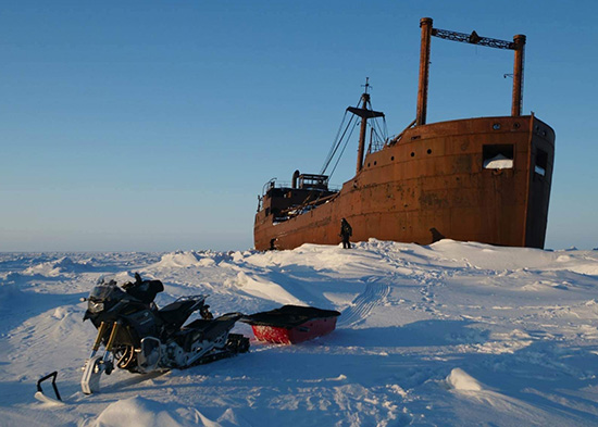 Oliver Solaro, rusted ship abandoned on the snow. Gertrude snow bike in foreground.
