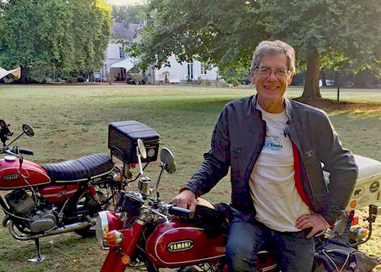 Stuart Holding and two 250-cc Yamaha motorcycles.