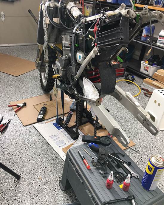 Motorcycle maintenance, DRZ400e in the garage.
