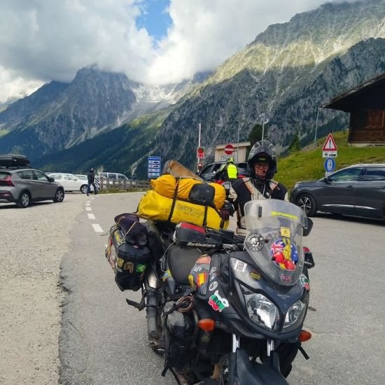 Melanie and Greg Turp, Fully loaded adventure motorcycle in Austria.