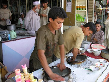 Making ice cream. freezing milk inside the drum rotated in a bath of ice.