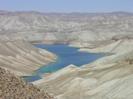 Stark contrast of desert mountains and bright blue lake 