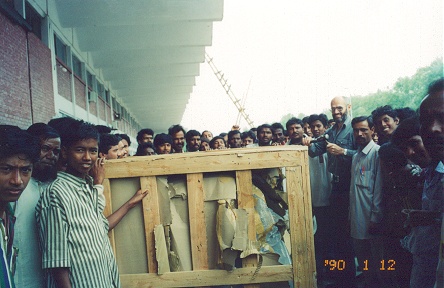 The crated bike arrives with many onlookers