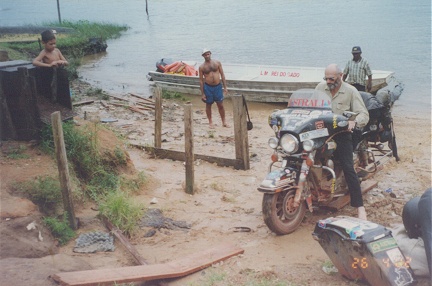 Riding the bike out of the muddy landing place up the wooden ramp