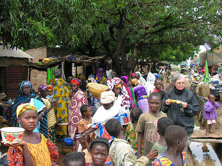 Kay enjoying a cob of maize (hard corn) at the local markets