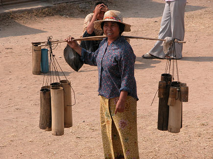 Selling palm wine from bamboo jars