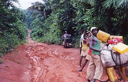 Bicycles the only transport operating, carrying petrol in and palm oil out