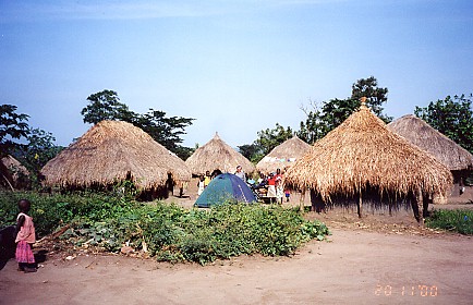 Our tent alongside their grass huts, an overnight stop