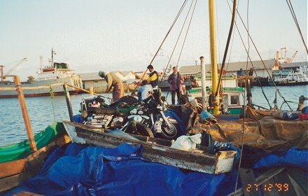 Us and the motorcycle slept on deck of this small boat for three nights