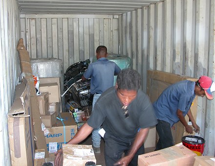 Unloading the container to extract the motorcycle