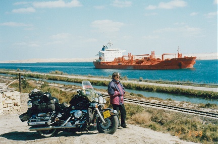 Ship navigating the Suez Canal, note our Egyptian numberplate on the front wheel
