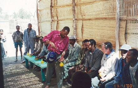 Drinking the potent home made brew, yellow, with the locals