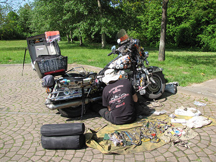 Trying to repair the motorcycle at a rest stop