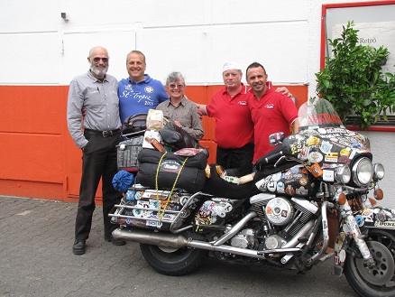 Bruno and his staff at his import business, note the gift products on the motorcycle