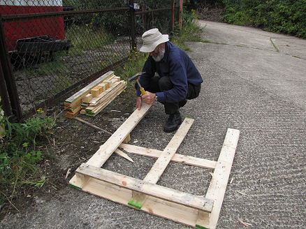 Breaking up a couple of pallets for wood for an engine crate