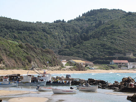 Small fishing boat harbour and beach at our apartment on Corfu