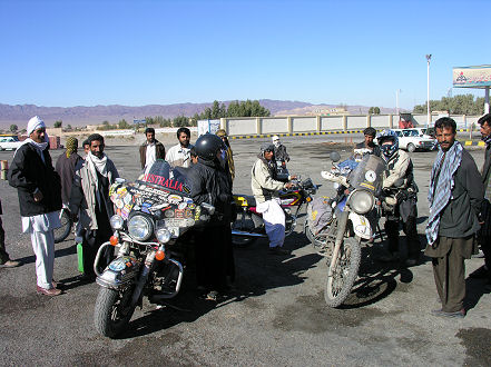 Getting petrol from drums near the border with Pakistan