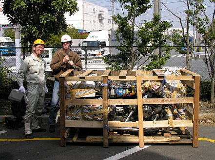 Chris and the immaculately dressed worker to uncrate the motorcycle