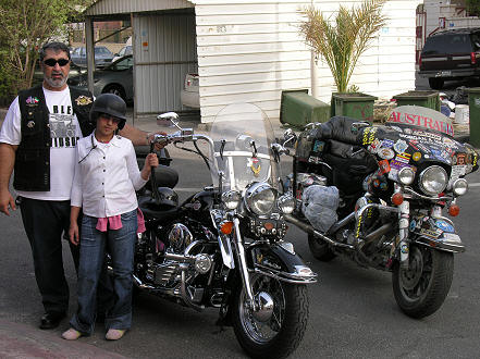 Abu Ali, outside his house with his daughter, who also likes motorcycles and sometimes rides with him.