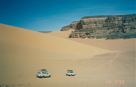 Moving sand dunes between rugged mountains