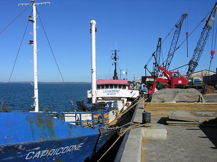 Loading our boat, Capricorne, by hand, with timber on big tides