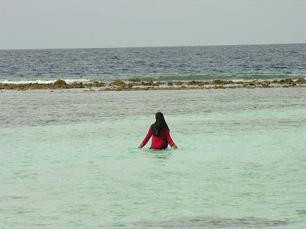 Local woman cooling off in the lagoon on Viligi