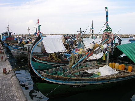 Local boats carry sand and gravel to Male