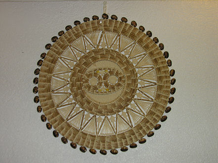 Intricate wall hanging of pandanus and kauri shells