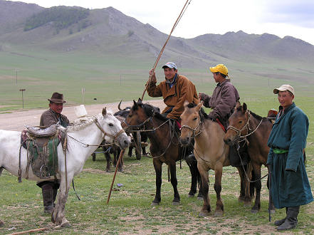 Herders with their long lassoo pole moving stock to better pastures