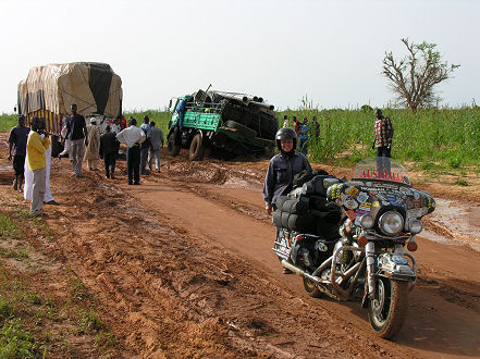 Muddy detour around a waterhole and bogged trucks