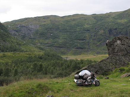 A wild camp below a switchback mountain road