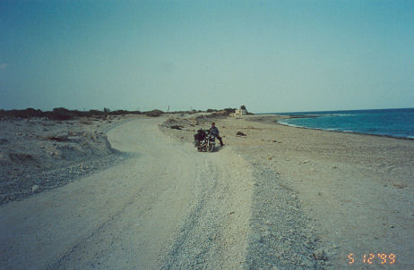 Dirt road follows the coastline
