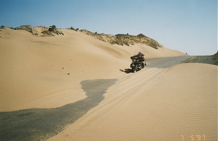 Desert road with sand drifting