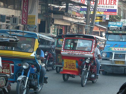 Motorcycle taxi's (tricycles) in a busy street Zamboanga